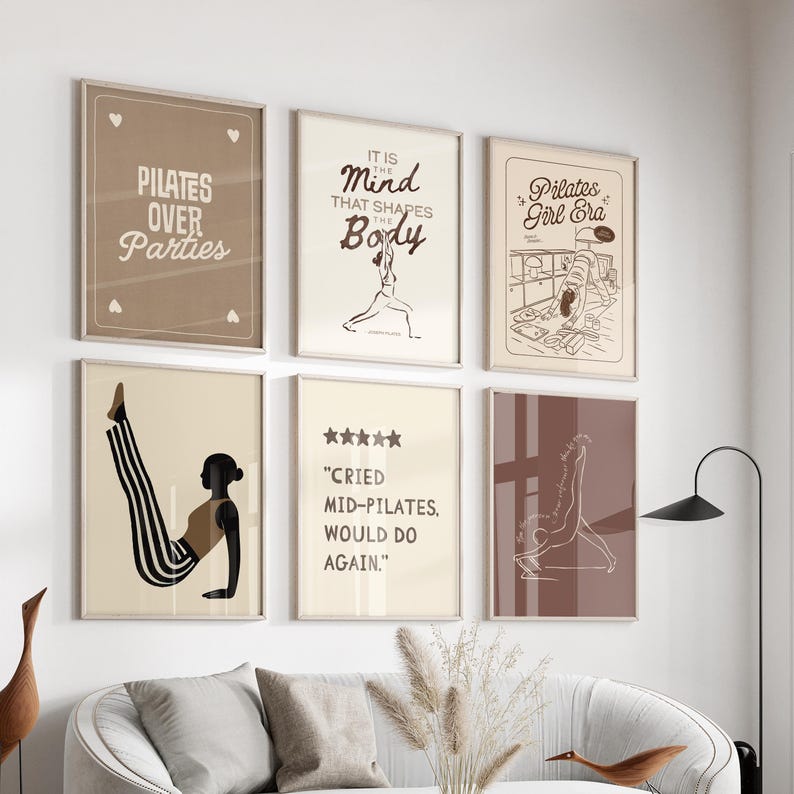 May include: A collection of six framed art prints with Pilates-themed designs. The prints feature text like "Pilates Over Parties" and "It is the Mind that Shapes the Body." The color palette includes beige, brown, and black, with minimalist illustrations of Pilates poses.
