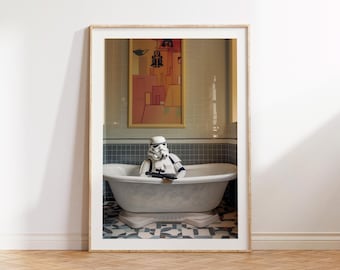 May include: Framed print featuring a Stormtrooper in a white bathtub, holding a blaster. The bathroom has a vintage aesthetic with a framed artwork on the wall. The floor has a patterned tile design. The frame is a light wood color.
