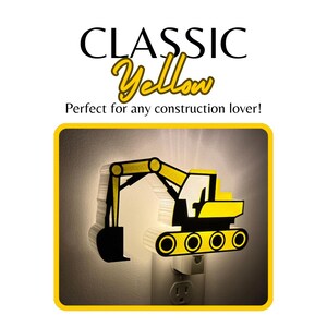 May include: A yellow and black excavator-shaped night light plugged into a wall outlet. The light emits a soft glow from behind the construction vehicle silhouette. The text CLASSIC Yellow and Perfect for any construction lover! is visible.