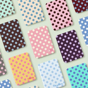 May include: A collection of rectangular card holders featuring various polka dot patterns in colors including mint, cream, pink, brown, yellow, and blue. Each holder displays a unique two-letter monogram or a name such as Olivia or Karren.