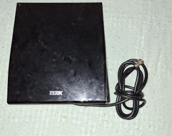 May include: A black TERK antenna with a black cord. The antenna is rectangular and has the brand name TERK printed on the front. The cord is coiled and has a connector at the end.