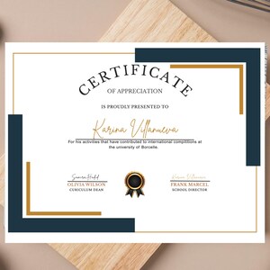 May include: A certificate of appreciation with a gold and navy blue border. The certificate reads "CERTIFICATE OF APPRECIATION" and "IS PROUDLY PRESENTED TO Karina Villanueva". Below the name is text about international competitions. Signatures and titles are at the bottom.
