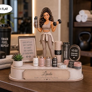 May include: A custom 2D flat figurine of a person in workout attire holding a water bottle and dumbbell, displayed on a wooden base with the name Linda. Includes miniature gym accessories, a sign reading Great Results Don't Happen By Chance, and a timer.