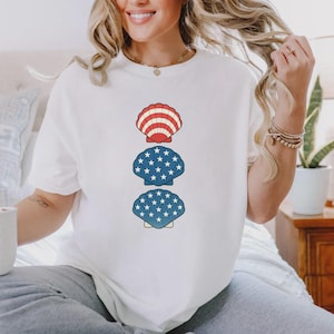 Koszulka z muszlami na 4 lipca, zabawna, akwarelowa koszulka z muszlami, prezent dla miłośników plaży, patriotyczna koszulka dla dziewcząt w kolorze czerwono-białym i niebieskim, koszulka dla miłośników muszelek