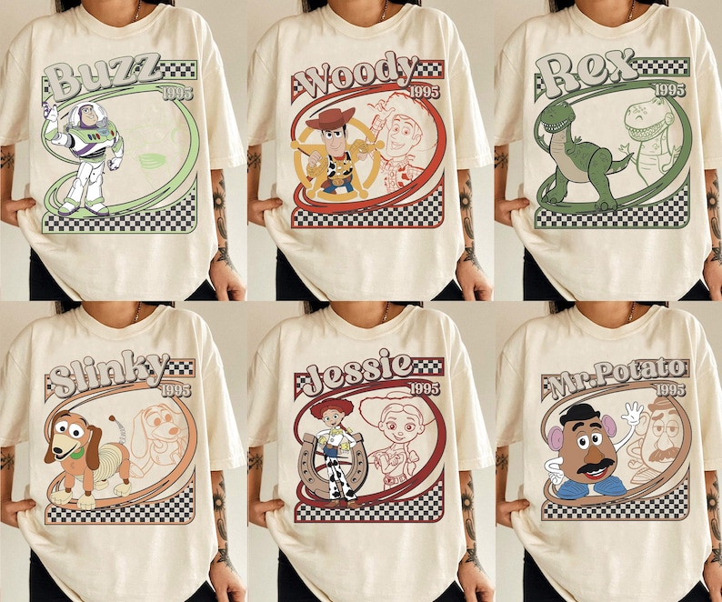 May include: Cream-colored t-shirts featuring cartoon characters Buzz, Woody, Rex, Slinky, Jessie, and Mr. Potato Head. Each shirt has a unique design with the character's name and the year 1995 in a retro style.