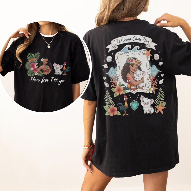 May include: Black t-shirt with a vibrant graphic inspired by an animated film. The front displays a character, a pig, and a rooster with the text "How far I'll go." The back design features the text "The Ocean Chose You."