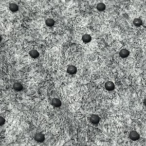 May include: A textured, fibrous gray surface featuring a repeating pattern of small, dark, circular studs arranged in a grid. The material appears to have a coarse, woven, or matted consistency with a monochromatic, high-contrast appearance.