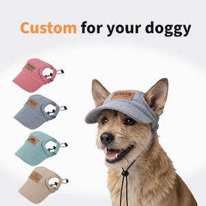 May include: A corduroy pet visor hat with an adjustable chin strap and a leather-style patch. The text Custom for your doggy appears at the top. Four colour variations are shown: pink, blue, teal, and beige, with one worn by a brown dog.