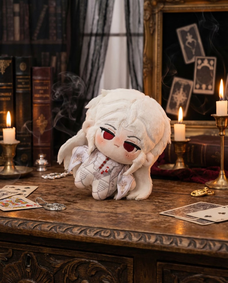 May include: A plush doll with white fur and red eyes, dressed in a white outfit with intricate details. The doll is set on a wooden table with playing cards and candles, creating a gothic or fantasy theme.