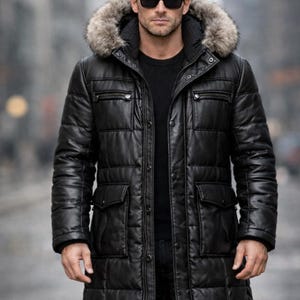 May include: Black leather puffer coat with a fur-trimmed hood. The coat features a quilted design, multiple pockets, and a button-up closure. The model is wearing sunglasses.