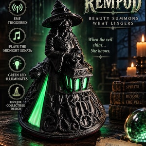 May include: A black witch figurine wearing a pointed hat and holding a lantern that emits a green LED glow. The base features intricate scrollwork. Text on the image includes MAGCOMM WITCH REMPOD, BEAUTY SUMMONS WHAT LINGERS, When the veil thins... She knows, and MORE THAN A PROP... IT'S A CONVERSATION WITH THE UNKNOWN.