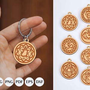 May include: Wooden keychains with chakra symbols. One keychain is held by a hand, while several others are displayed. The keychains are round with a light brown finish and feature intricate designs representing the chakras. The image also includes file type icons.