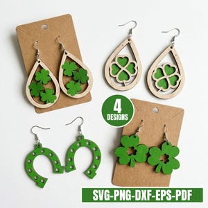 May include: Four pairs of St. Patrick's Day earrings in various designs. Two pairs feature green shamrocks, one pair is a green horseshoe, and the last pair has a shamrock design. The earrings are displayed on brown cardstock.