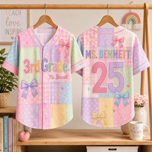 May include: A short-sleeve button-down baseball jersey featuring a pastel patchwork pattern of gingham, hearts, and stars. The front displays the text 3rd Grade and Ms. Bennett with bows. The back shows Ms. Bennett and the number 25 with bows.
