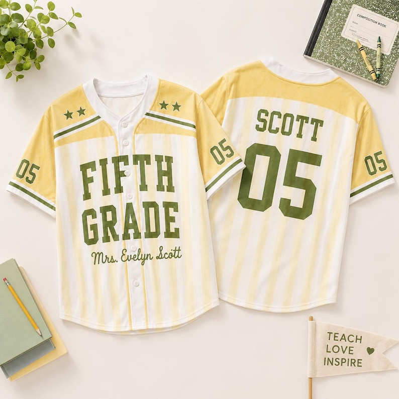 May include: Two baseball-style jerseys with yellow and white vertical stripes. The front features the text FIFTH GRADE and Mrs. Evelyn Scott in green. The back displays the name SCOTT and the number 05 in large green block lettering.