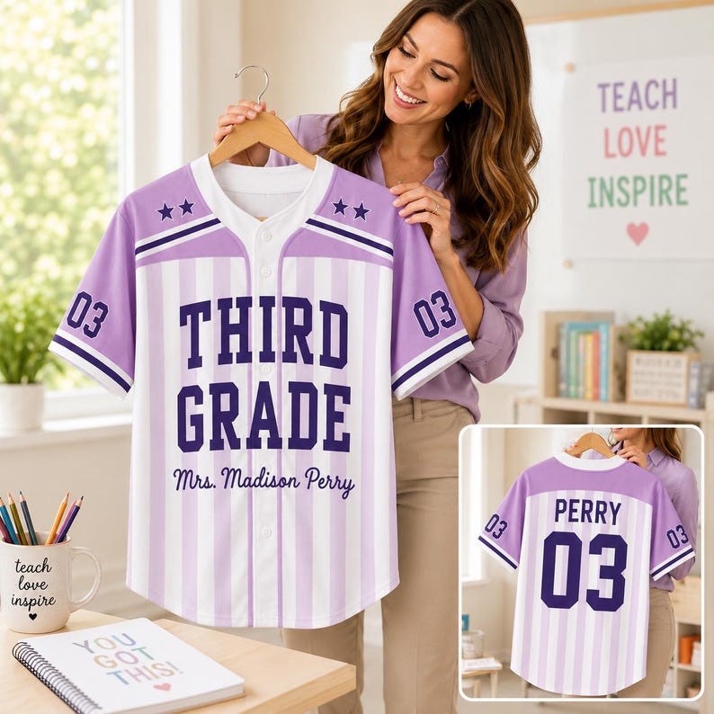 May include: A short-sleeve button-down baseball jersey with light purple and white vertical stripes. The front features the text THIRD GRADE and Mrs. Madison Perry in dark purple, with the number 03 on the sleeves. The back displays PERRY 03.