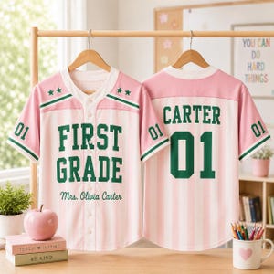 May include: Two button-down baseball jerseys with pink and white vertical stripes, green trim, and dark green lettering. The front displays "FIRST GRADE" and "Mrs. Olivia Carter" with stars. The back features "CARTER" and the number "01".
