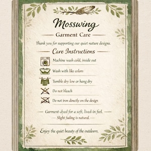 May include: A rectangular garment care instruction card with a green leaf border and a feather illustration. It features the text Mosswing Garment Care, care icons for washing, drying, bleaching, and ironing, and notes on fabric fading and nature.
