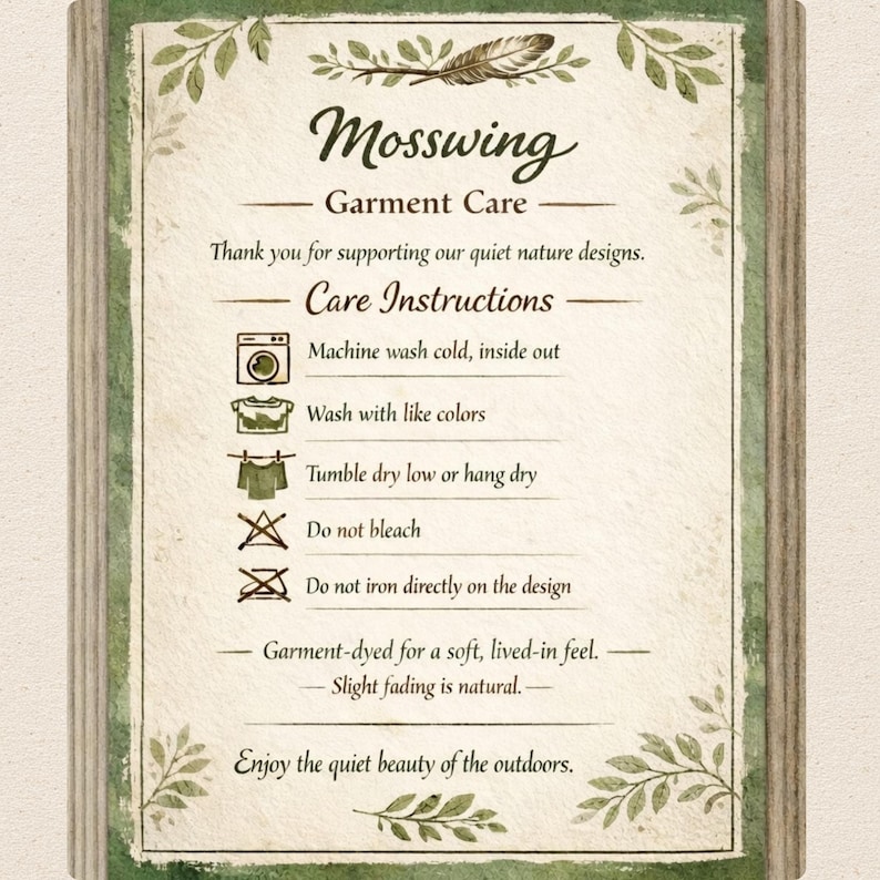 May include: A rectangular garment care instruction card with a green leaf border and a feather illustration. It features the text Mosswing Garment Care, care icons for washing, drying, bleaching, and ironing, and notes on fabric fading and nature.