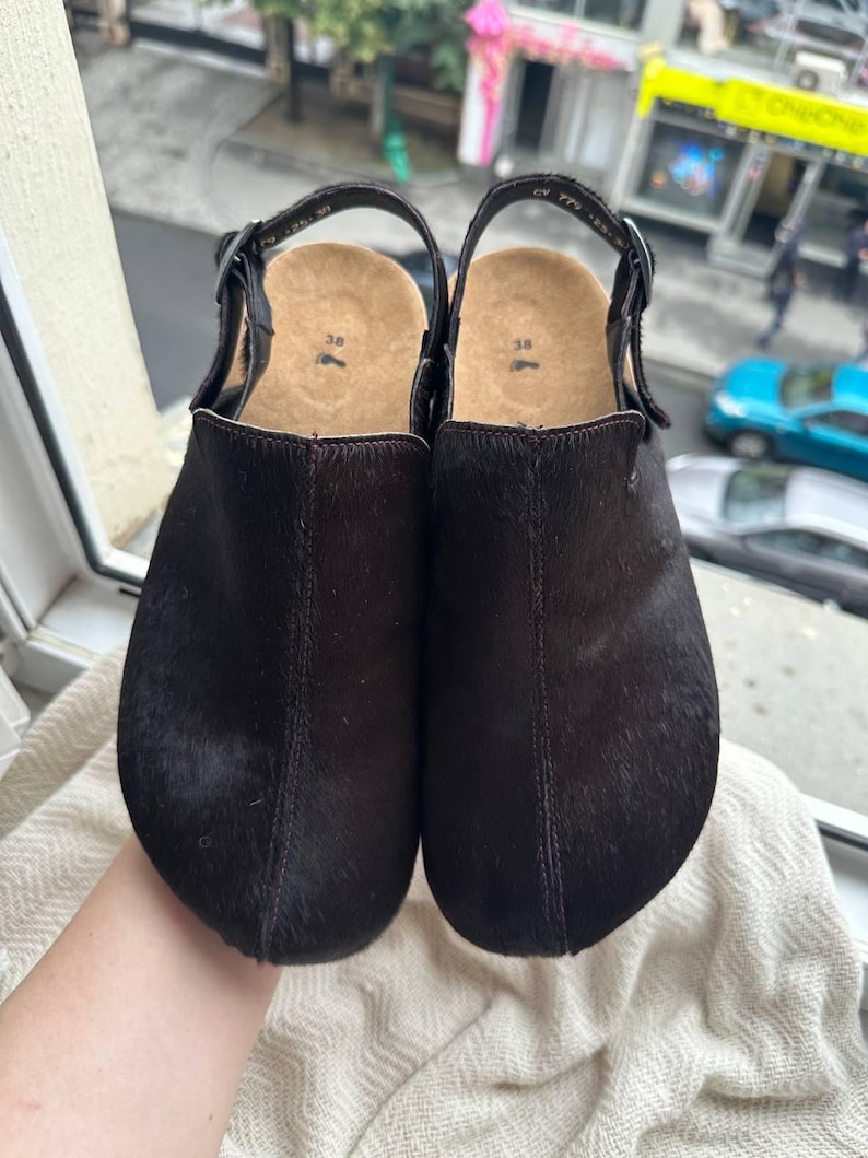 Dark brown suede anatomical clogs with round toe and adjustable buckle strap, handmade footwear