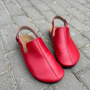 Red leather anatomical clogs with round toe and orthopedic cork footbed, top view