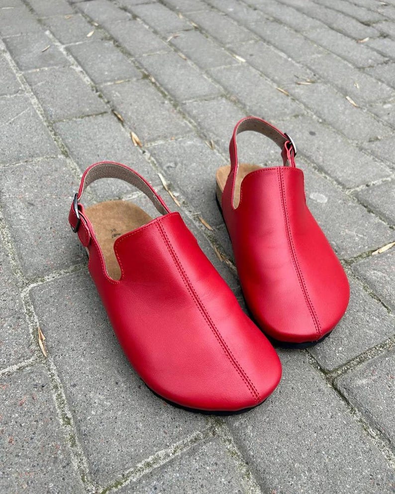 Red leather anatomical clogs with round toe and orthopedic cork footbed, top view