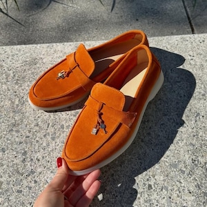 Handmade women's orange suede loafers made from premium Italian suede with comfortable wide fit design, lightweight sole and elegant gold hardware.