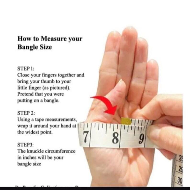 May include: An instructional graphic titled How to Measure your Bangle Size, featuring text steps and a white measuring tape wrapped around a hand with fingers closed and thumb tucked, showing a measurement between 7 and 9 inches.