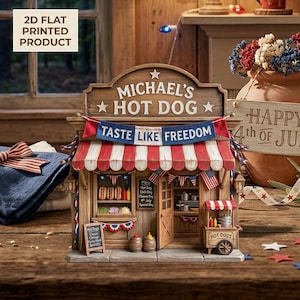 May include: A miniature wooden hot dog stand with a red, white, and blue awning and the text "Michael's Hot Dog." The stand features a small menu, American flags, and the phrase "Taste Like Freedom."