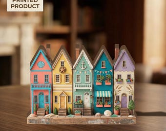May include: A 2D flat printed product featuring a row of five colorful houses in pink, yellow, light green, teal, and light purple. Each house has unique architectural details like balconies, windows, doors, and coastal decorations like shells.
