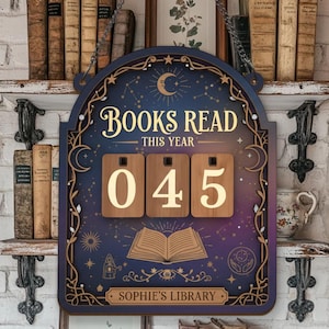 May include: A wooden sign with the words "BOOKS READ THIS YEAR" and the number "045" displayed. The sign has a celestial design with a crescent moon and stars. The words "SOPHIE'S LIBRARY" are at the bottom.