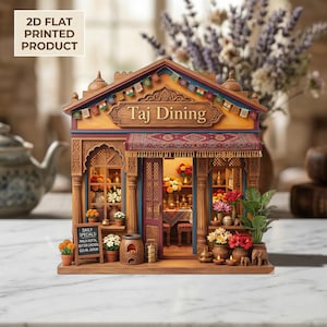May include: A detailed miniature of "Taj Dining" restaurant, with intricate architectural details, a red awning, and a sign. The facade is adorned with colourful flags and floral arrangements. A small chalkboard displays daily specials.