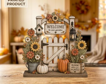 May include: A 2D flat printed decorative garden gate sign featuring a white picket fence, a hanging sign that reads WELCOME to our garden, a birdhouse, a lantern, sunflowers, pumpkins, and a crate with the text BLOOM where you are planted.