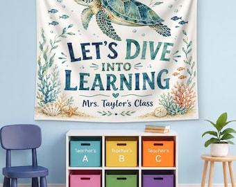 May include: A wall tapestry featuring a watercolor sea turtle, coral, and fish with the text "LET'S DIVE INTO LEARNING" and "Mrs. Taylor's Class". Below, a white storage unit holds six colorful bins labeled Teacher's A, B, and C.