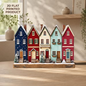 May include: A 2D flat printed wooden decoration featuring a row of five colorful houses on a snowy base. The houses are dark blue with stars, red, cream, light blue, and red. Each house has windows, doors, and small evergreen trees or pinecones.