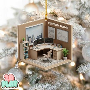 May include: A miniature office scene Christmas ornament. The ornament features a desk with three computer monitors, a chair, and a bookshelf. The background includes a cityscape and the text "CUSTOM NAME".