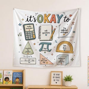 May include: A white wall tapestry featuring colorful math-themed illustrations and motivational text. Elements include a calculator, a notebook with a pencil, a protractor, a cube, and geometric shapes with phrases like it's OKAY to make mistakes.