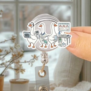 May include: A white badge reel featuring a cartoon of three geese dressed as respiratory therapists. One goose wears glasses and headphones, another holds a medical device, and the third is next to a lung function chart. The text "Respiratory Therapy Team" is visible.