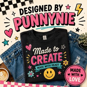 May include: A black t-shirt featuring the text "Made to CREATE" in pink and white, with "MADE WITH HEART" on a blue banner. The design includes a yellow smiley face, colorful flowers, and stars. Above the shirt, the text "DESIGNED BY PUNNYNIE" appears.
