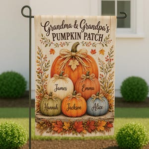 May include: A rectangular garden flag featuring a light wood-grain background with the text Grandma & Grandpa's PUMPKIN PATCH. The design includes a large central orange pumpkin and four smaller pumpkins in white, orange, green, and blue, each tied with a twine bow and personalized with the names James, Emma, Hannah, Jackson, and Alice.