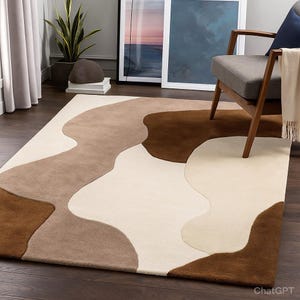 May include: A rectangular area rug with an abstract design in shades of brown, beige, and cream. The rug features organic, flowing shapes that create a modern and stylish look. The rug is placed on a dark wood floor.
