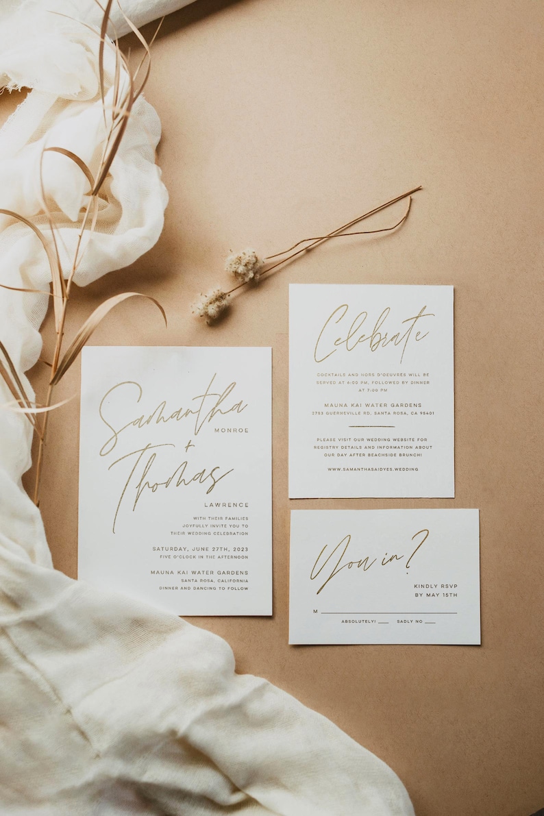 May include: A wedding invitation suite with gold calligraphy on white cardstock. The invitation features the couple's names, "Samantha & Thomas", the date, "Saturday, June 27th, 2023", and the location, "Mauna Kai Water Gardens, Santa Rosa, California". The RSVP card reads "You in?" with a line for guests to indicate their response.