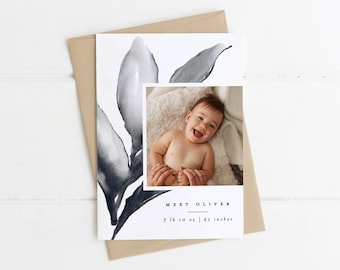 May include: A white card with a black and gray watercolor leaf design. A photo of a baby boy is in the center of the card. The text "Meet Oliver" is below the photo, followed by "7 lb 10 oz | 21 inches".