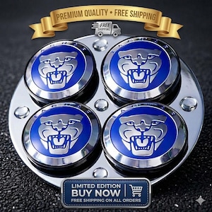 May include: Set of four Jaguar car wheel center caps. Each cap features a blue background with a silver Jaguar logo. The caps are mounted on a chrome base. The image includes text that says "LIMITED EDITION BUY NOW".