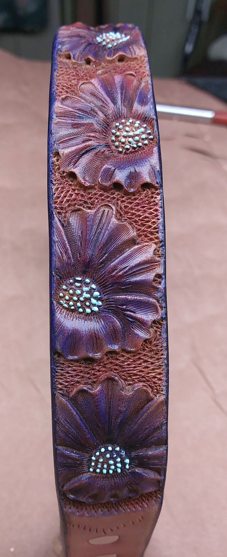 Purple floral design for this handmade dog tag collar. The flowers are hand tooled for a ever lasting design. it fits 18.25" over the head size by 1" wide.