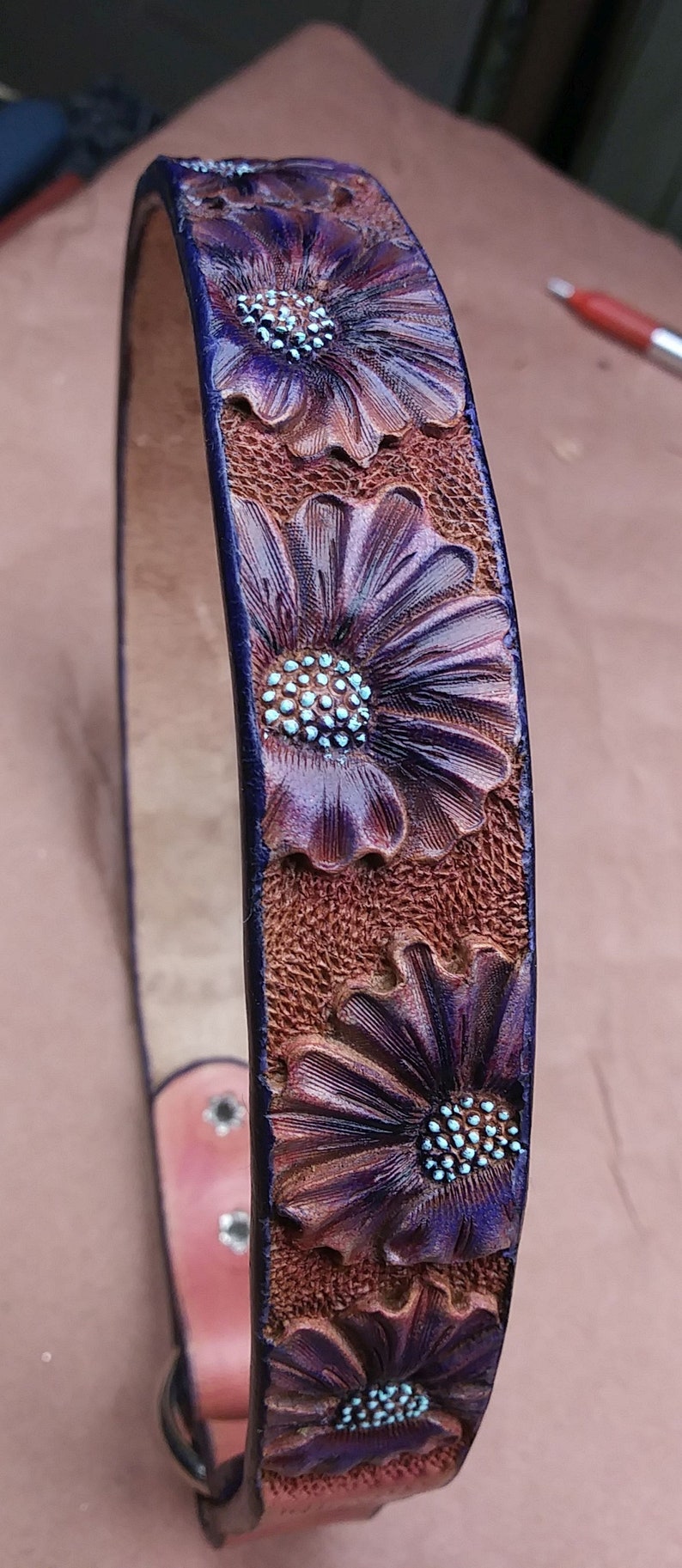 Purple floral design for this handmade dog tag collar. The flowers are hand tooled for a ever lasting design. it fits 18.25" over the head size by 1" wide.