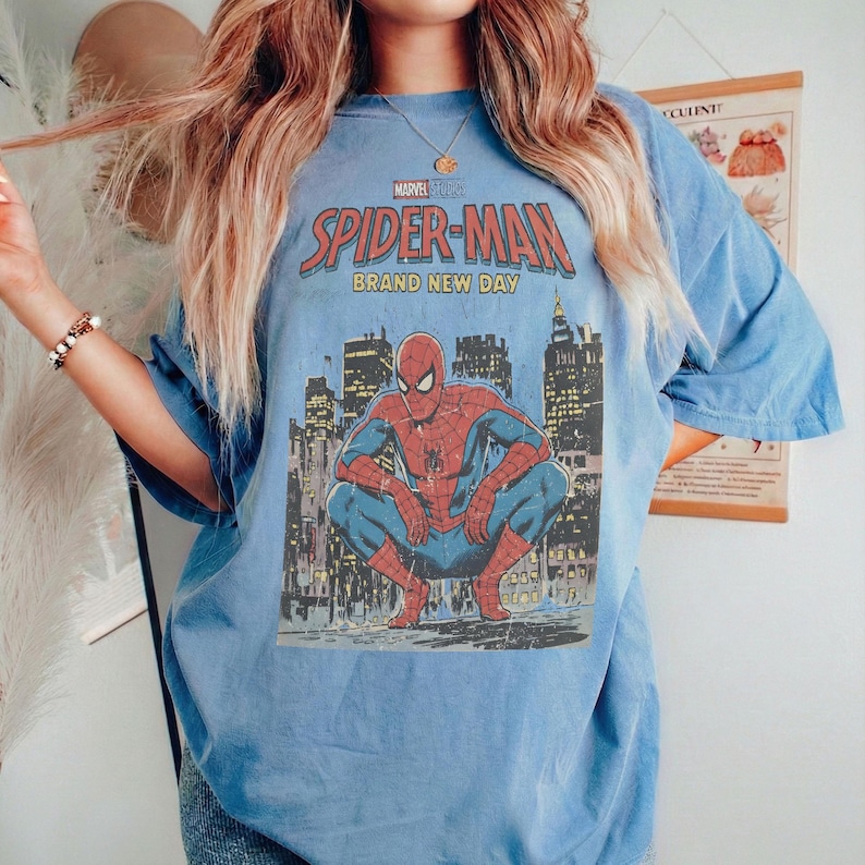 May include: A white ceramic mug with a black handle and the text "But First, Coffee" in a black, handwritten-style font. The mug is on a white surface.