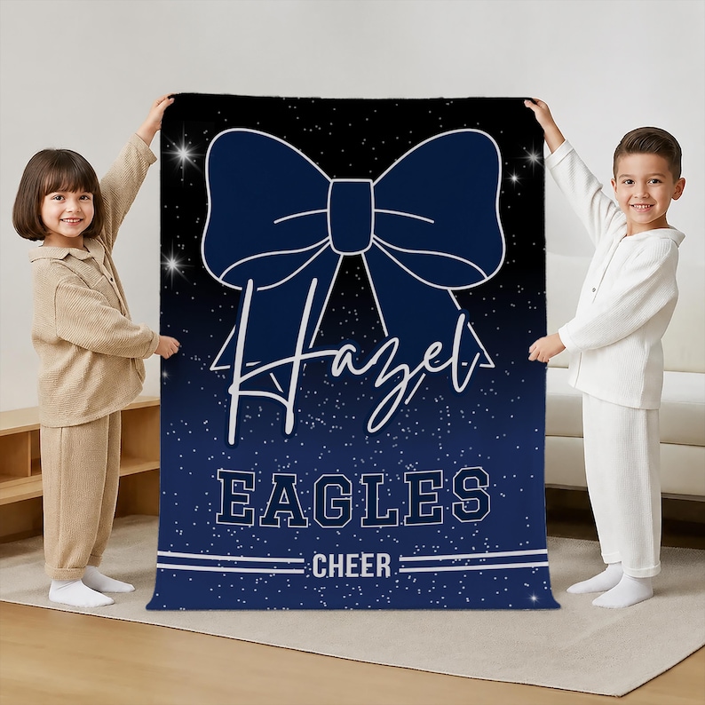 May include: A rectangular blanket featuring a dark blue background with a white starfield pattern. A large navy blue cheer bow graphic is centered at the top. The text "Hazel" is written in white script, followed by "EAGLES" and "CHEER" in white block letters.