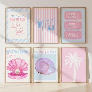 May include: Six framed art prints with a seaside theme. The prints feature illustrations of a beach scene, a bikini, tickets, a seashell, a spiral shell, and a palm tree. The colour palette includes pink, blue, and beige.