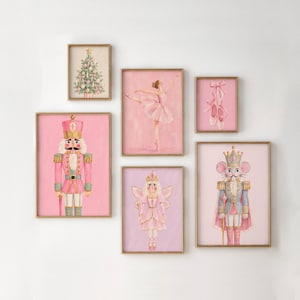 May include: A gallery wall set of six framed prints featuring a Christmas tree, a ballerina in a pink tutu, ballet slippers, a nutcracker, a fairy, and a mouse king, all rendered in shades of pink, gold, and soft pastel tones.